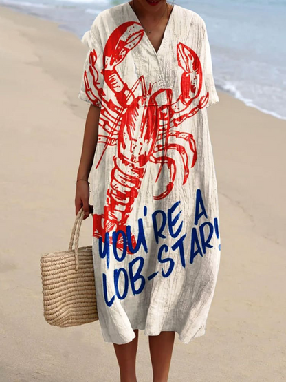 Kasandra - Sukienka z lejącym się materiałem z marynistycznym wzorem